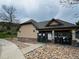Pool house with stone accents and covered seating, surrounded by rock landscaping at 11328 W Radcliffe Dr, Littleton, CO 80127