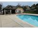 Outdoor community pool featuring a clubhouse, a green hillside, and lots of sunshine at 11328 W Radcliffe Dr, Littleton, CO 80127
