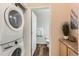 Convenient laundry area with stacked washer and dryer next to a vanity and nearby bathroom at 2769 W Riverwalk Cir # E, Littleton, CO 80123