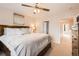 Bedroom with a king-size bed, ceiling fan, and an en-suite bathroom entry at 2769 W Riverwalk Cir # E, Littleton, CO 80123