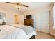 Relaxing bedroom featuring a king-size bed, ceiling fan, dresser, closets, and access to an en-suite at 2769 W Riverwalk Cir # E, Littleton, CO 80123