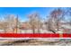 View of neighborhood backyard area with red fence in winter season at 8330 Zuni St # 219, Denver, CO 80221