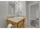 Comfortable bathroom featuring single sink vanity, updated mirror and lighting at 8330 Zuni St # 219, Denver, CO 80221