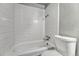 Clean bathroom showcasing white tiled shower over tub and elongated toilet at 8330 Zuni St # 219, Denver, CO 80221