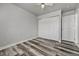 Bedroom with wood floors, ceiling fan, closet, and white doors at 8330 Zuni St # 219, Denver, CO 80221