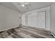 Bedroom with wood flooring, ceiling fan, closet and doorway to hall and en-suite bathroom at 8330 Zuni St # 219, Denver, CO 80221