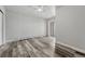 Spacious bedroom featuring modern gray-toned wood flooring and a sliding glass door to a balcony at 8330 Zuni St # 219, Denver, CO 80221