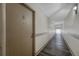 Long, well-lit hallway with durable flooring, leading to a bright exit at 8330 Zuni St # 219, Denver, CO 80221