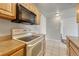 Functional kitchen with essential appliances and ample counter space at 8330 Zuni St # 219, Denver, CO 80221