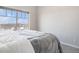 Bright bedroom featuring a plush bed, soft carpet floors, and a large window with neighborhood views at 9318 Las Ramblas Ct # R, Parker, CO 80134