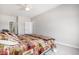 Bedroom with light gray walls, wood-themed blanket, and an attached ensuite bathroom at 9318 Las Ramblas Ct # R, Parker, CO 80134