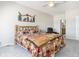 Spacious bedroom with rustic wood bedframe, decorative wall art and an ensuite bathroom at 9318 Las Ramblas Ct # R, Parker, CO 80134