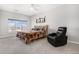 Primary bedroom with window view and reclining chair next to decorative mountain art and rustic headboard at 9318 Las Ramblas Ct # R, Parker, CO 80134