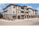 Inviting condo building with stone accents, balconies, and well-maintained landscaping at 9318 Las Ramblas Ct # R, Parker, CO 80134