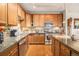 Close up of modern kitchen with wood cabinets and countertops with stainless steel appliances and fixtures at 9318 Las Ramblas Ct # R, Parker, CO 80134