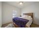 Neutral bedroom with a queen bed, ceiling fan, and shuttered window for natural light at 5437 S Granby Ct, Aurora, CO 80015