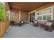 Relaxing covered patio with outdoor seating, stone accents, and lattice privacy screen, perfect for enjoying the outdoors at 5437 S Granby Ct, Aurora, CO 80015