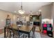 Dining area seamlessly connects to a modern kitchen with stainless steel appliances, dark cabinets and hardwood floors at 5437 S Granby Ct, Aurora, CO 80015