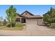 Charming single-Gathering home with a stone and brown siding, a well-manicured front yard, and an attached two-car garage at 5437 S Granby Ct, Aurora, CO 80015
