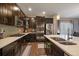 Modern kitchen with stainless steel appliances, quartz countertops, dark wood cabinetry, and a stylish backsplash at 5437 S Granby Ct, Aurora, CO 80015