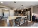 Bright kitchen with a large center island, stainless steel appliances, dark wood cabinets, and pendant lighting at 5437 S Granby Ct, Aurora, CO 80015