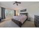 Comfortable main bedroom with a king-sized bed, shuttered windows, and neutral decor at 5437 S Granby Ct, Aurora, CO 80015