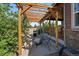 Outdoor entertaining area featuring a wooden pergola, patio seating, a grill, and a fire pit for gatherings at 5437 S Granby Ct, Aurora, CO 80015