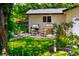 Landscaped backyard with lush green lawn and charming patio area for relaxation at 4590 Grove St, Denver, CO 80211