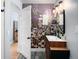 Bathroom with a floral accent wall, modern vanity, and open doorway at 4590 Grove St, Denver, CO 80211