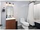 Bathroom features modern vanity, black mirror, and combo tub shower at 4590 Grove St, Denver, CO 80211