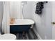 Bathroom with a clawfoot tub and blue wood-look flooring at 4590 Grove St, Denver, CO 80211