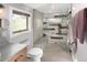 Contemporary bathroom featuring a glass shower, tiled walls, and modern fixtures at 4590 Grove St, Denver, CO 80211