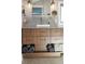 Bathroom vanity with wooden drawers, white vessel sink, and stylish fixtures at 4590 Grove St, Denver, CO 80211