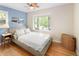 Bright bedroom with a large bay window, ceiling fan, and hardwood floors at 4590 Grove St, Denver, CO 80211