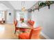 Dining area with an industrial light fixture, open shelving, and a rustic wood table at 4590 Grove St, Denver, CO 80211