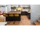 Spacious kitchen with center butcher-block island, yellow stools, hardwood floors, and modern design at 4590 Grove St, Denver, CO 80211