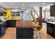 Modern kitchen featuring a butcher block island, stainless steel appliances, and open floor plan at 4590 Grove St, Denver, CO 80211