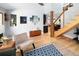 Bright living room with hardwood floors, staircase, and modern decor at 4590 Grove St, Denver, CO 80211
