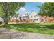 A large grassy backyard with a small fence separates these multi-story townhomes at 6722 S Independence St, Littleton, CO 80128