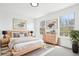Bright bedroom with natural light, wood frame bed, two large windows, and matching dresser at 6722 S Independence St, Littleton, CO 80128