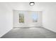 Bright, spacious room with two large windows and plush gray carpet flooring at 6722 S Independence St, Littleton, CO 80128