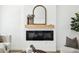 Modern fireplace with decorative mirror, mantel, and stylish accessories at 6722 S Independence St, Littleton, CO 80128