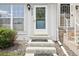 Inviting front entrance featuring a white door with diamond patterned glass and concrete steps at 6722 S Independence St, Littleton, CO 80128