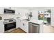 Contemporary kitchen with stainless steel appliances, white countertops, and modern fixtures at 6722 S Independence St, Littleton, CO 80128