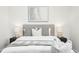 Comfortable main bedroom with a soft color palette, plush pillows, and bedside lamps at 6722 S Independence St, Littleton, CO 80128