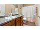 Bathroom featuring a vanity with single sink and a shower tub combo with curtain at 9626 E 105Th Pl, Commerce City, CO 80640