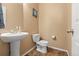 Charming half bath featuring a stylish pedestal sink and a tile floor at 9626 E 105Th Pl, Commerce City, CO 80640
