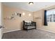 A simple, carpeted bedroom with a crib and wall shelves at 9626 E 105Th Pl, Commerce City, CO 80640