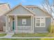 Charming home featuring a covered front porch, two stories, a manicured lawn, and stylish curb appeal at 9626 E 105Th Pl, Commerce City, CO 80640