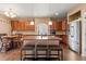 Bright kitchen boasts a center island with sink, stainless steel refrigerator, and pendant lighting at 9626 E 105Th Pl, Commerce City, CO 80640